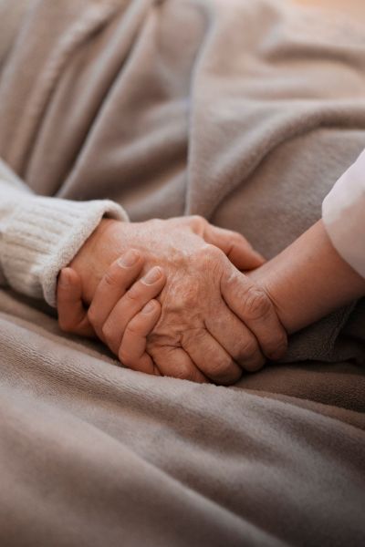 person-holding-elderly-woman-hand