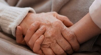 person-holding-elderly-woman-hand
